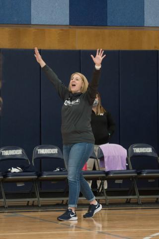 Coach Lauren Sanders celebrates a point 